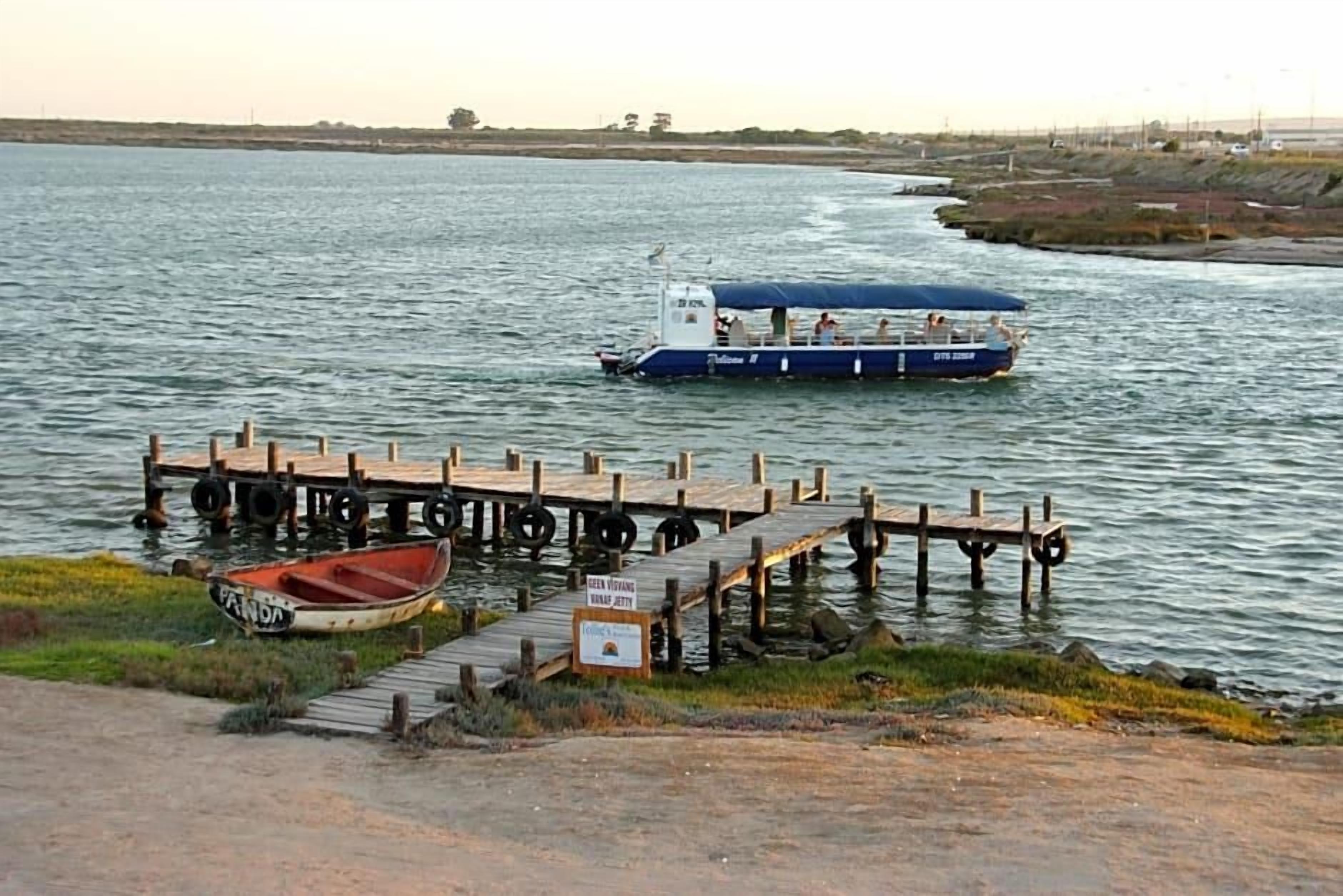 A river with a dock and a boat.