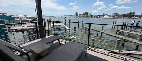A deck with a view of a marina, including boats and docks.