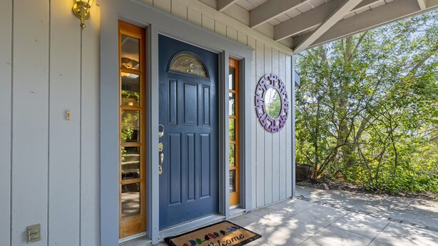 A blue door with a glass panel, a welcome mat, and a decorative wall piece. - ✨ 3-King Beds / HotTub / EV Charger / Mountain View / Walk to River & Dining (Three Rivers)