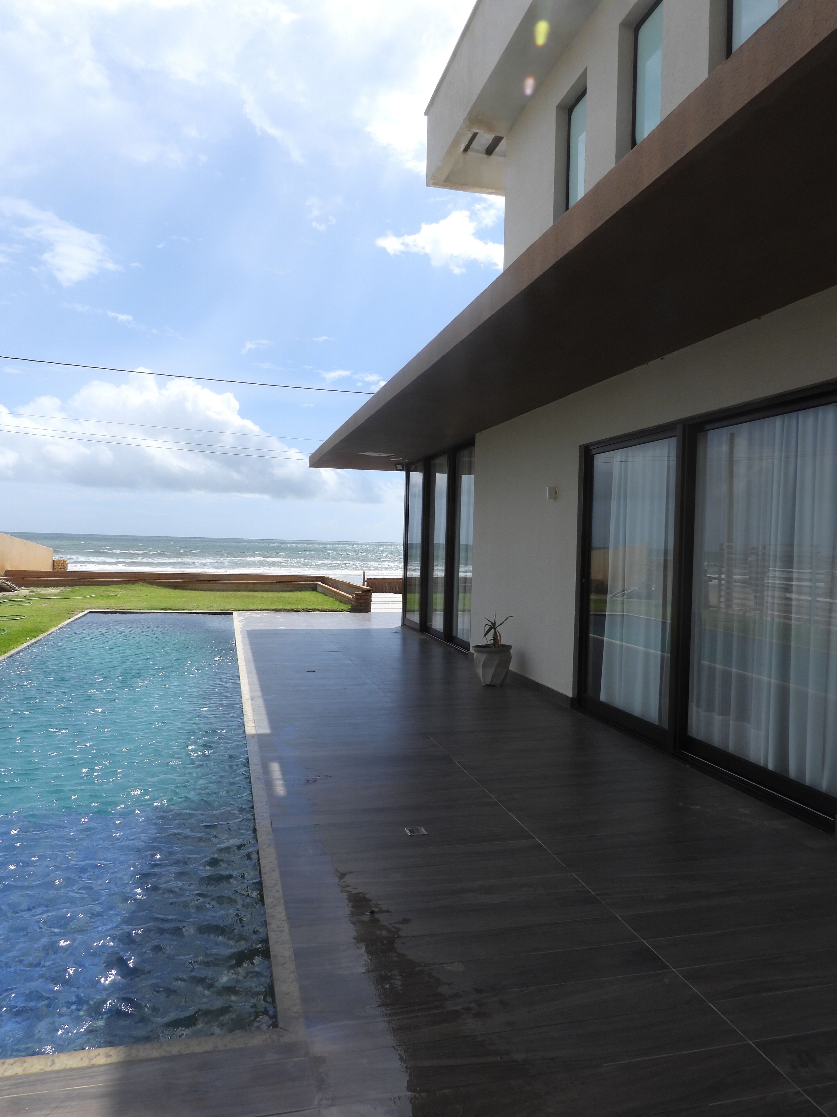A modern building with a pool and a view of the ocean.