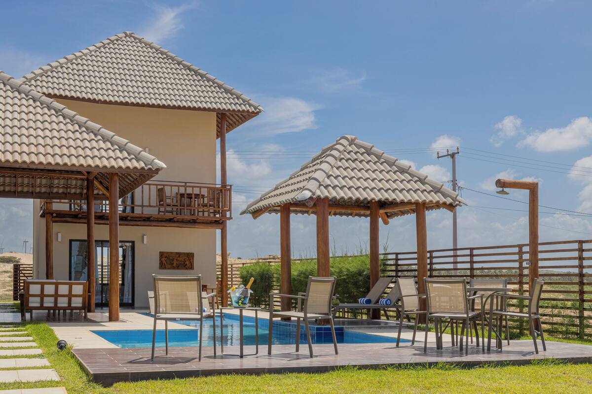 A pool area with lounge chairs and a pergola structure.