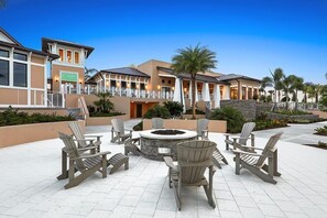 Relax by the fire pit in our tranquil courtyard, surrounded by lush greenery and Adirondack chairs.