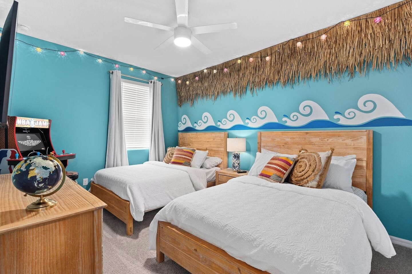 A room with two beds, a globe, and a gaming console.