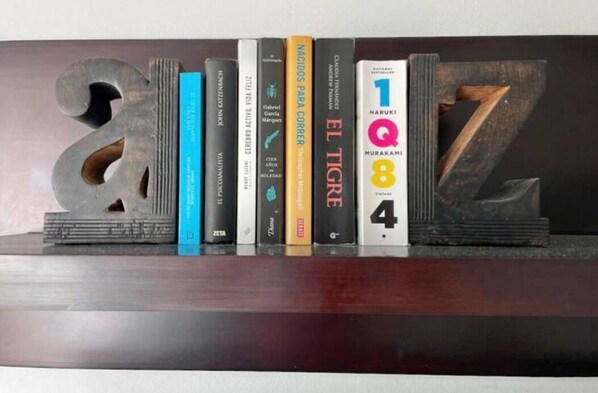A bookshelf with books and decorative numbers.