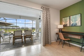 Enjoy a view of the pool and surrounding landscape from this room's large window.