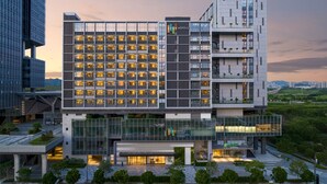 A modern hotel with multiple floors, large windows, and a glass facade. - EVEN Hotel Shenzhen Guangming Cloud Park by IHG (Shenzhen)