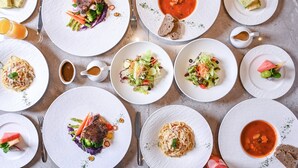 A table set with various dishes including pasta, salads, and soup, arranged neatly on white plates. - EVEN Hotel Shenzhen Guangming Cloud Park by IHG (Shenzhen)