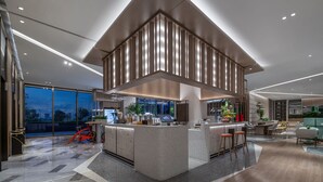 A modern kitchen with a central island, large windows, and a dining area with seating. - EVEN Hotel Shenzhen Guangming Cloud Park by IHG (Shenzhen)