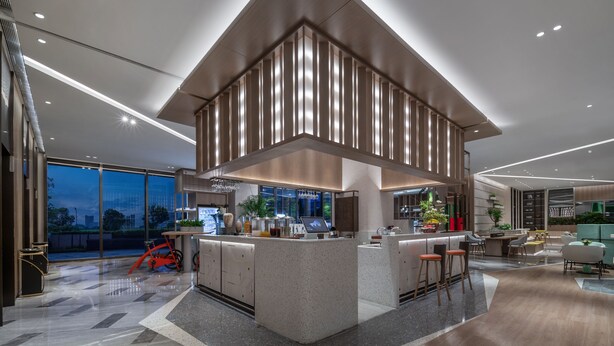A modern kitchen with a central island, large windows, and a dining area with seating. - EVEN Hotel Shenzhen Guangming Cloud Park by IHG (Shenzhen)