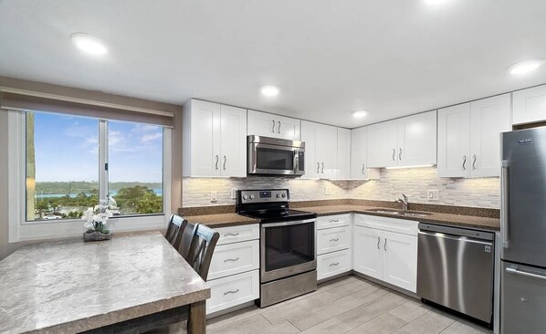 Enjoy meals in the kitchen with a scenic view, dining area, and stainless steel appliances.
