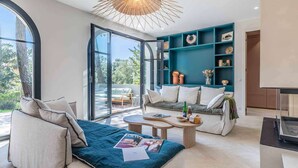 A modern living room with a sofa, coffee table, and a teal accent wall.