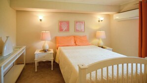 A bedroom with a bed, two bedside tables, two lamps, a dresser, and two wall-mounted light fixtures. - 3 min walk to beach - Bella Figura (5 bed) (Hastings)