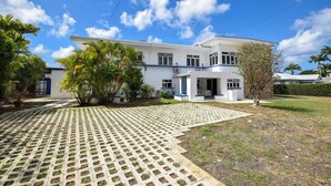 A two-story house with a paved driveway and a lawn. - 3 min walk to beach - Bella Figura (5 bed) (Hastings)