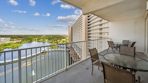 A balcony with a view of a river and a high-rise building. - 5 Pools, Gym, Beach Access at Laketown Wharf 1230 (Panama City Beach)