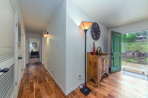 Enter a serene hallway leading to a garden view.
