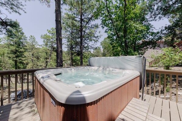 Relax in the hot tub on the deck surrounded by nature.