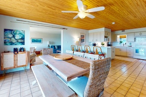 Relax in this inviting living area with a large dining table and comfortable seating.