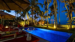 A poolside area with lounge chairs, a small pool, and palm trees at dusk. - Renovated 3BR Villa W/ Pool - Perfect for Couples , Bali Villa 2237 (Bali)
