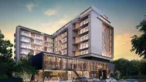 A modern multi-story hotel with a distinctive facade and a covered outdoor area. - Belleson Homes The Lennox (Accra)