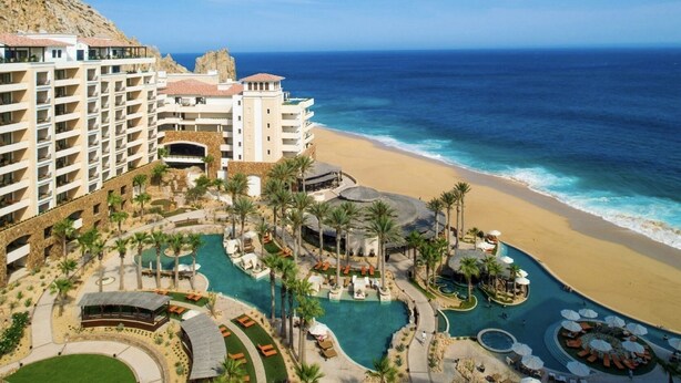 A resort with multiple swimming pools, a beach, and a mountainous backdrop. - Grand Solmar Resorts (Cabo San Lucas)