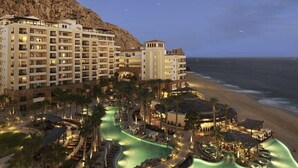 A resort with multiple buildings, a pool area, and a beach view. - Grand Solmar Resorts (Cabo San Lucas)
