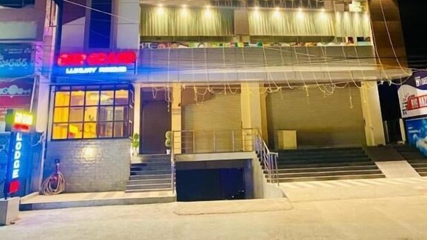 A multi-story hotel with a modern facade, featuring a prominent sign for 'Hotel Residences' and a visible entrance with steps leading up to the door. - PPH Living Gnr Grand Luxury Rooms (Madanapalle)