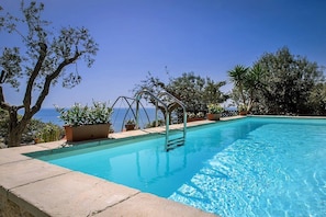 A rectangular swimming pool with clear blue water, surrounded by a stone deck. - Villa Ilona Piccola: A splendid and luminous two-story independent house which faces the sun and the sea, with Free WI-FI. (Massa Lubrense)
