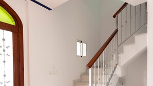 A staircase with white steps and a wooden handrail, leading to an upper floor. - Holiday Home 'Villa Zoe' with Sea View, Wi-Fi and Air Conditioning (Nerja)