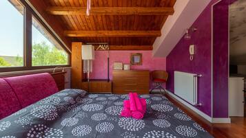 A bedroom with a bed, a dresser, a chair, a radiator, and a window.