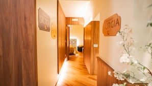 A wooden hallway with signs reading "STUDIO" and "MURGIA".