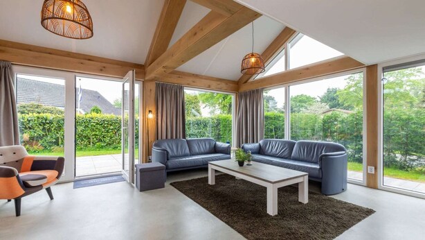 A modern living room with a sofa set, a coffee table, and a patterned rug. - Holiday Home near Beach Burgh-Haamstede (Burgh Haamstede)