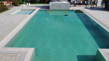 Seasonal outdoor pool, open 9:00 AM to 6:00 PM, pool umbrellas