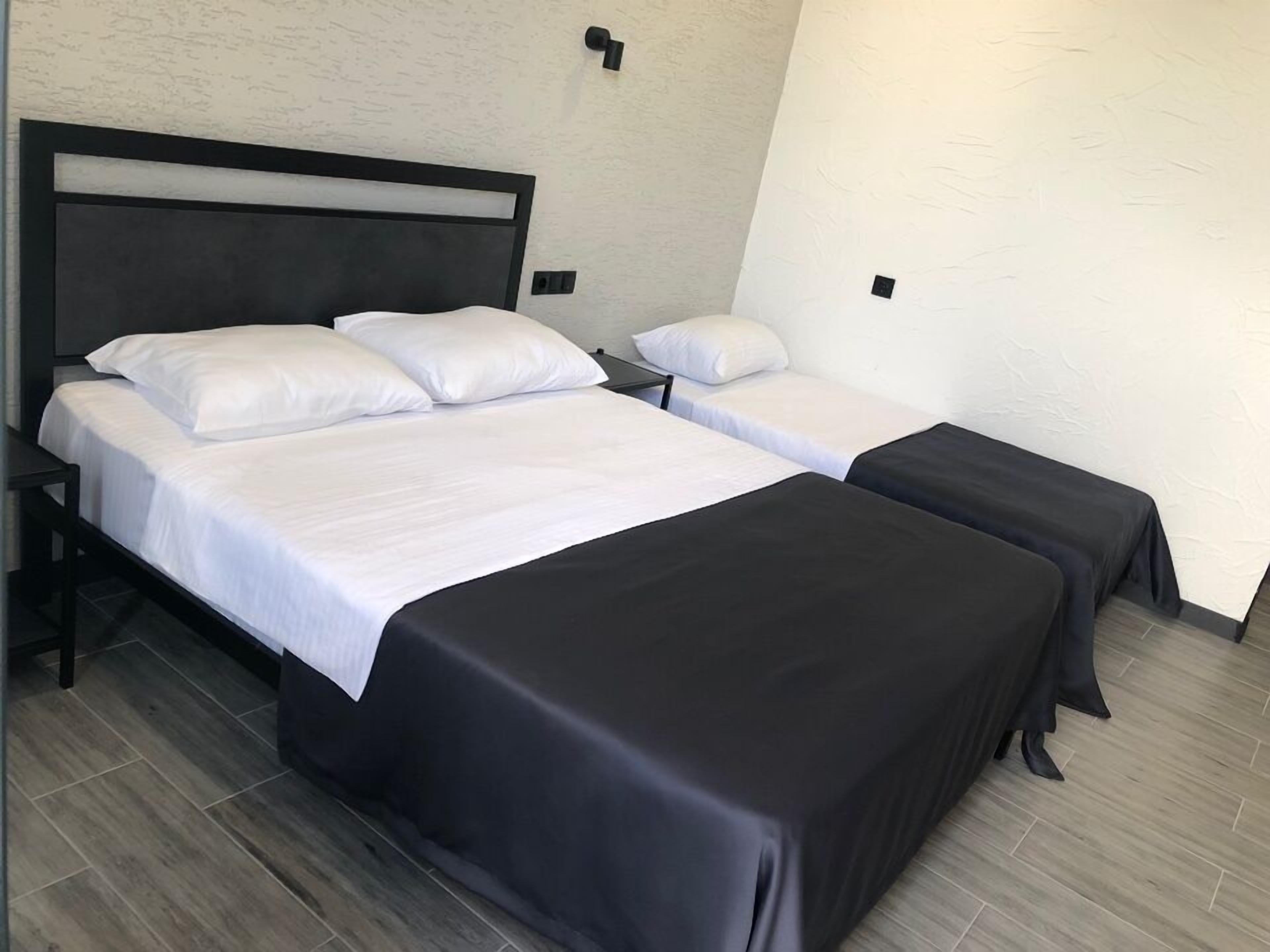 A hotel room with a double bed and a single bed.