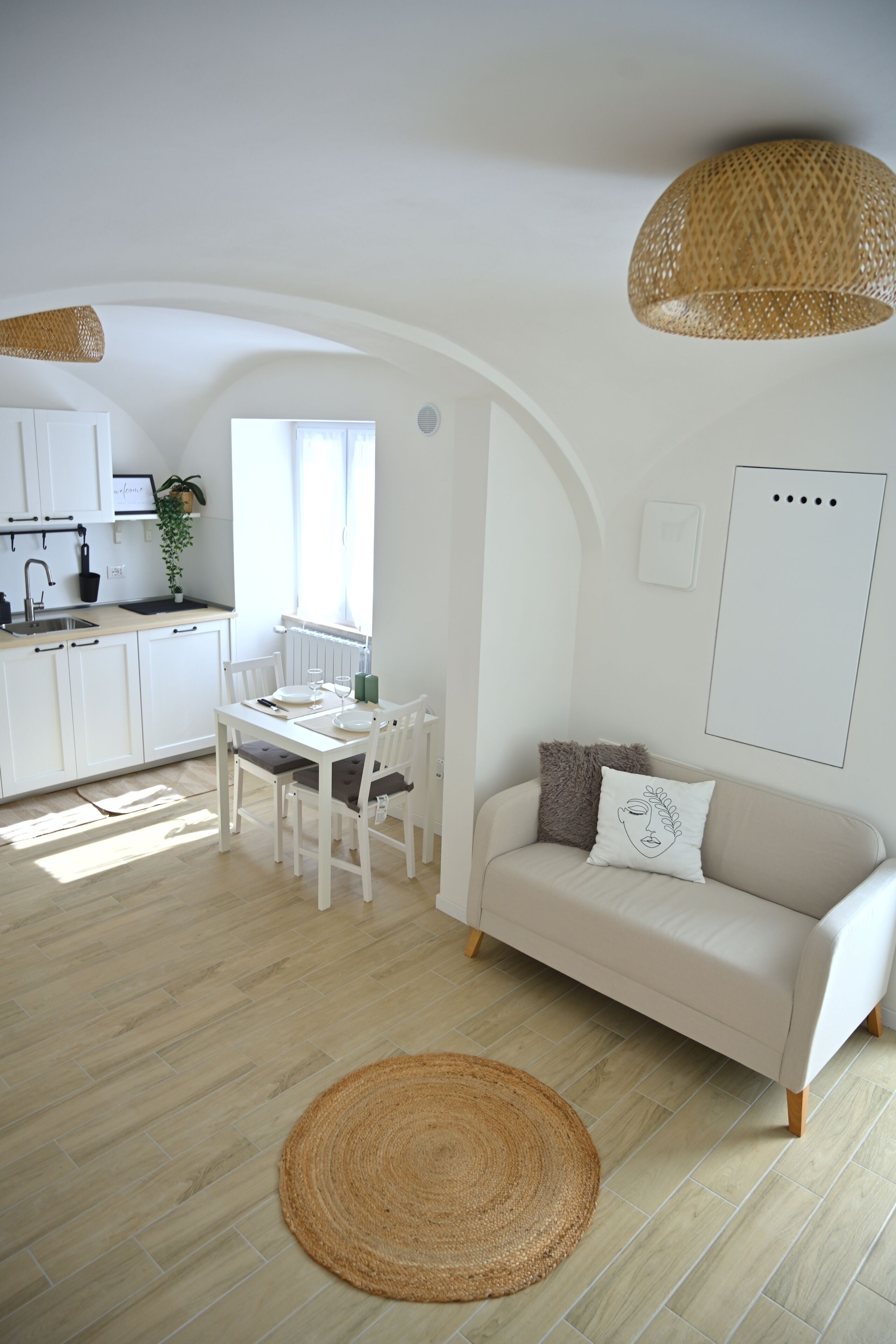 A modern, open-plan living space with a kitchen, dining area, and seating area.