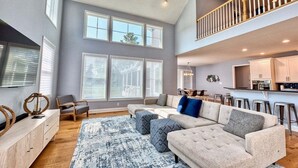 A spacious living room with a large sectional sofa, a wooden coffee table, and a ceiling fan. - *Private Hot Tub* 4BR Luxury Beach Home *37096* (Lewes)