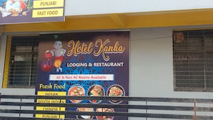 A hotel named "Hotel Kanha" with a signboard advertising AC & Non AC rooms, and a menu for Indian, South Indian, Chinese, and Punjabi fast food. - Hotel Kanha Ujjain (Ujjain)