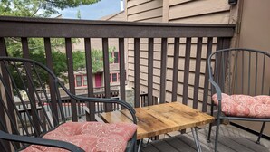 A balcony with two metal chairs and a wooden table, featuring patterned cushions. - Incredible MTN Views | In-Town | Pool | Hot Tub (Durango)