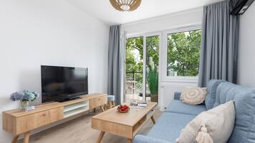 Comfort Apartment | Living area | 50-inch LED TV with satellite channels, TV