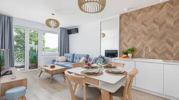 Comfort Apartment | Living area | 50-inch LED TV with satellite channels, TV
