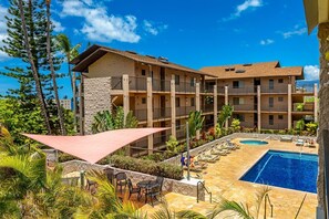 A hotel with a pool area, outdoor seating, and a view of the surrounding landscape. - Kihei Ali'i Kai D201 1 Bedroom Condo (Kihei)