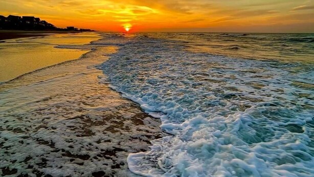 A beach with waves at sunset. - Clean New Townhome: Comfort and Convenience Await! (Hampstead)