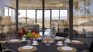A dining table set for four with a view of the countryside. - Villa Regina - Villa with pool (Noto)