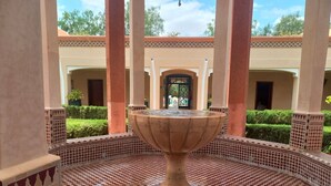 A courtyard with a central fountain, surrounded by tiled flooring and columns. - Relais d'ourika (Oulad Dlim)