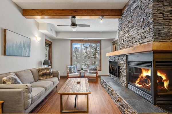 Living room with a smart TV & a gas-lit fireplace