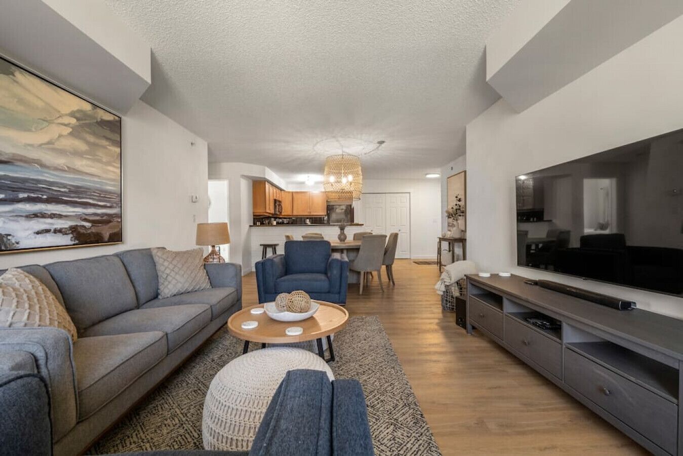 A modern living room with a sofa, coffee table, and TV.