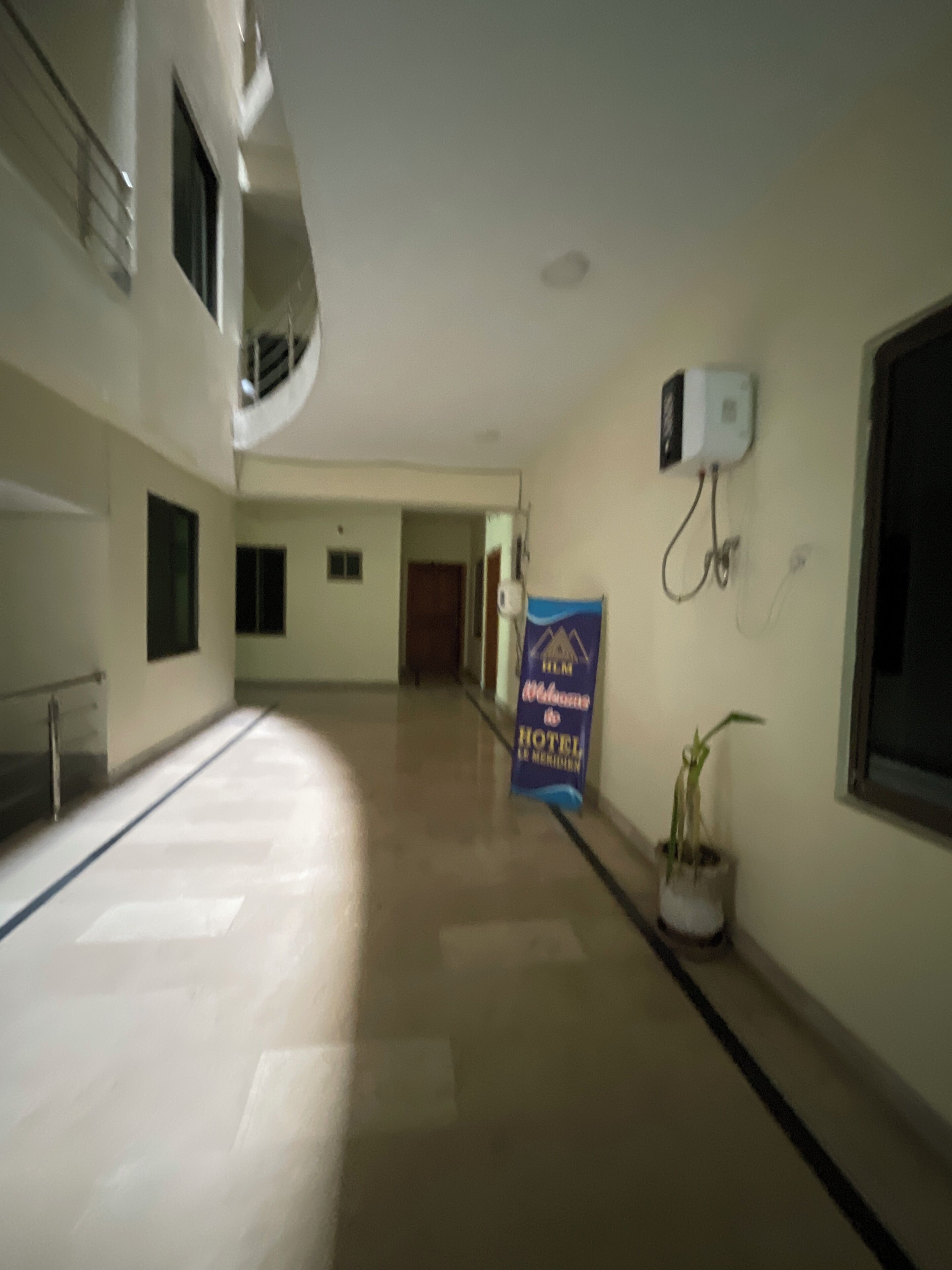 A hotel corridor with a sign for the "Hotel Le Meridien."