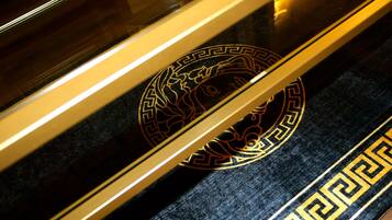 A close-up of a black and gold patterned carpet with a geometric design.