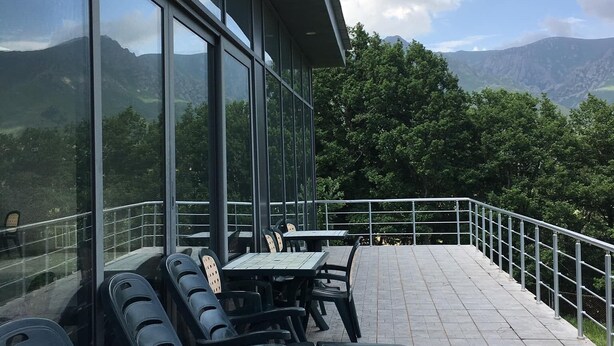 A terrace with outdoor seating and a view of mountains. - Ani Resort (Artavaz)