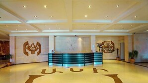 A spacious lobby with a reception desk, a large clock, and decorative wall art. - Ani Resort (Artavaz)
