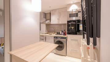 Signature appartement | Privékeuken | Een koelkast/vriezer, een magnetron, een kookplaat, een espressoapparaat